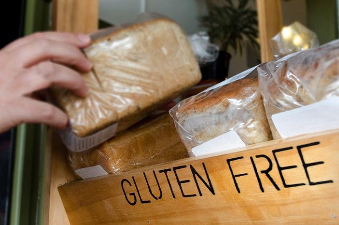 gluten free diet hand reaches for gluten-free bread in store
